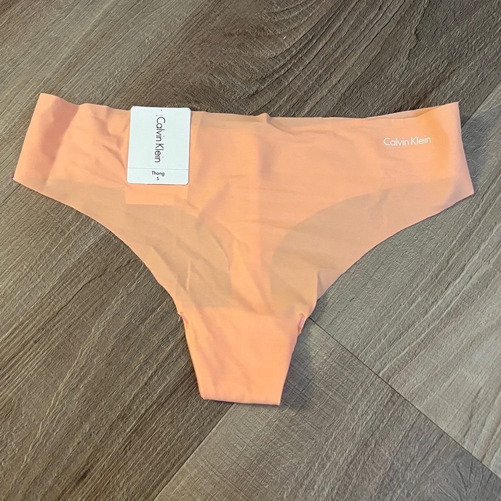 Calvin Klein no show thong in bright peach color
